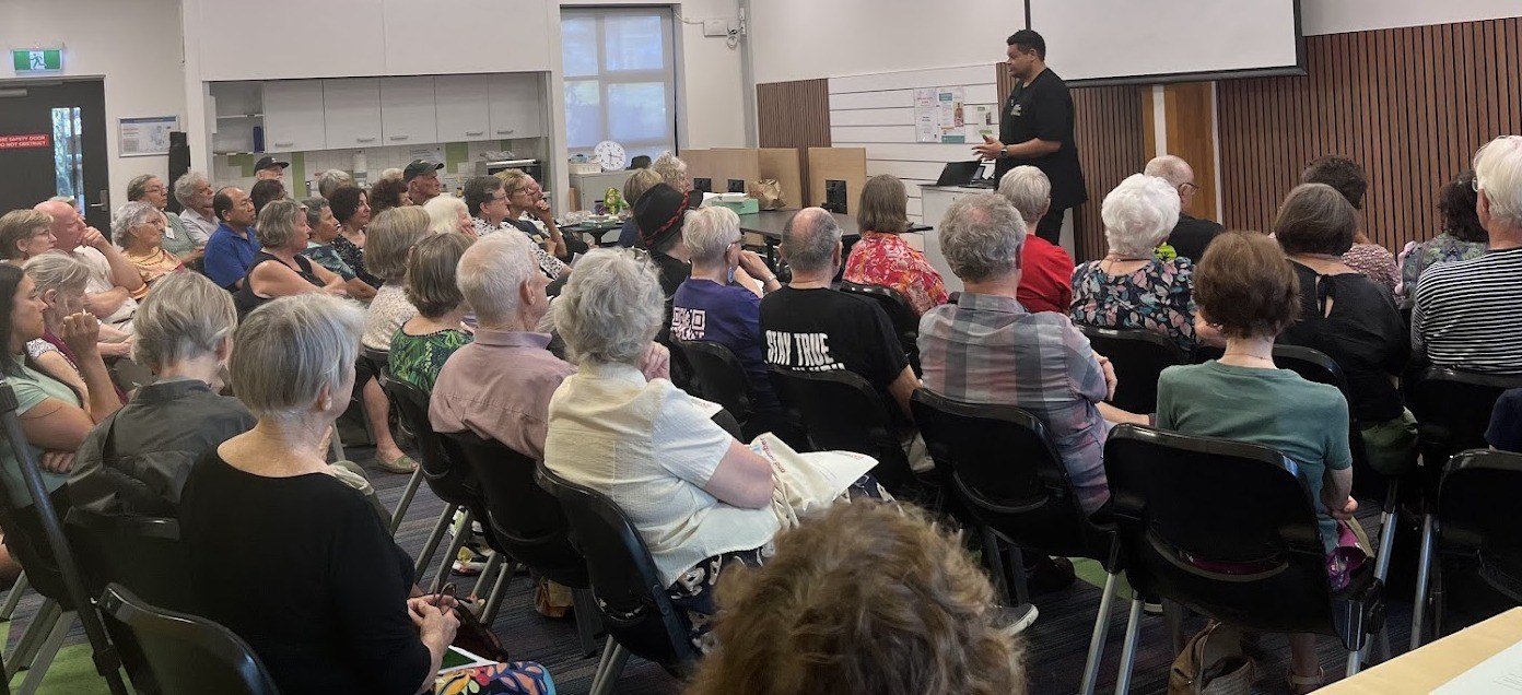 A full room of people seated at Mitchelton Library, listening to a speaker
